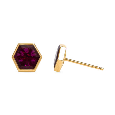 a pair of gold earrings with a purple stone