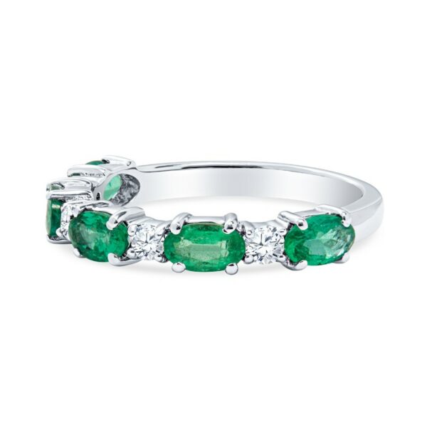 an emerald and diamond ring set in white gold