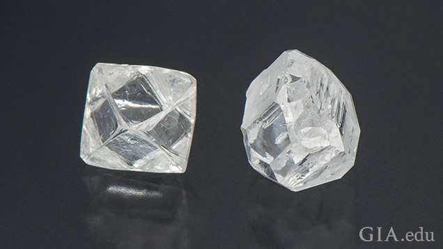 two diamonds are shown on a black surface