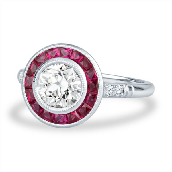 a white gold ring with a red and white diamond