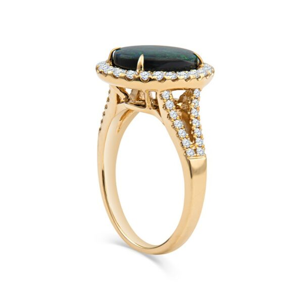a gold ring with a black stone and diamonds