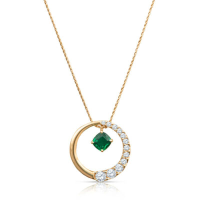 a gold necklace with a green stone in the middle