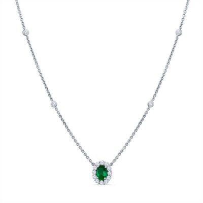 an emerald and diamond necklace on a white background