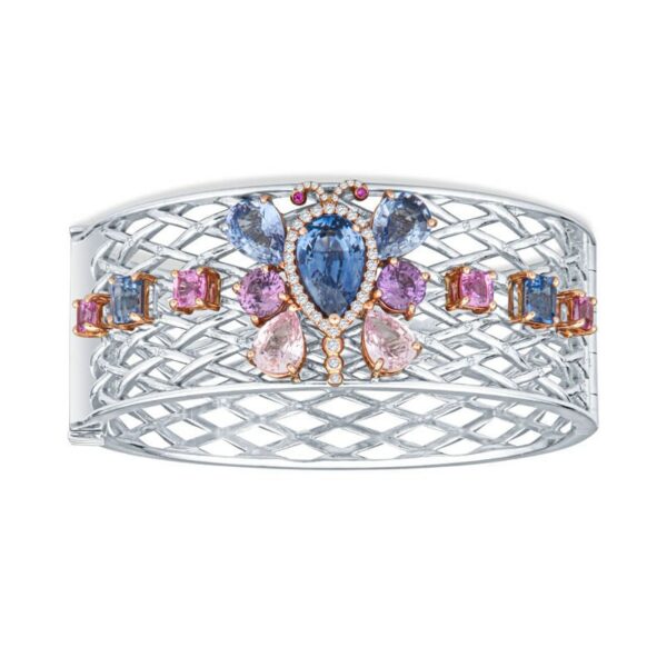 a white gold ring with pink and blue stones