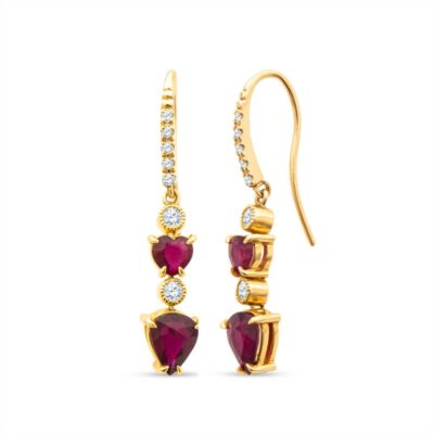 a pair of gold earrings with red stones