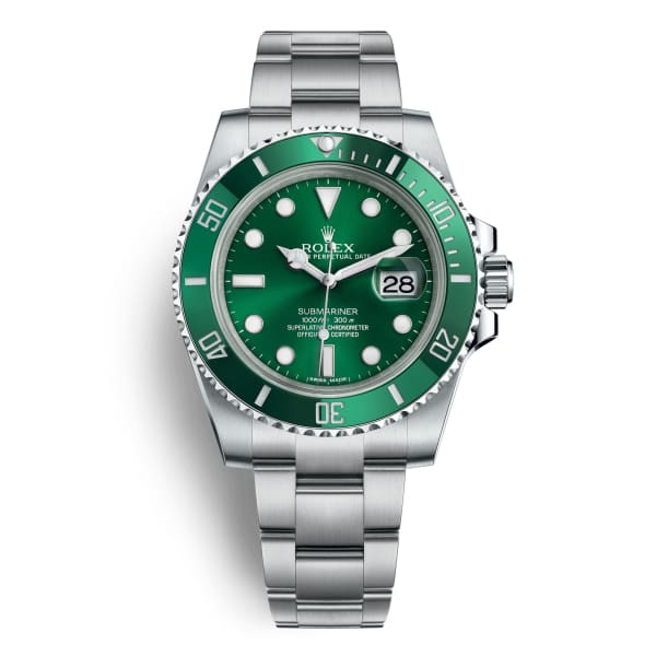a rolex watch with a green dial