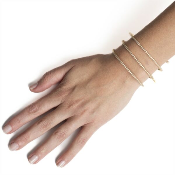 a woman's hand with three bracelets on it