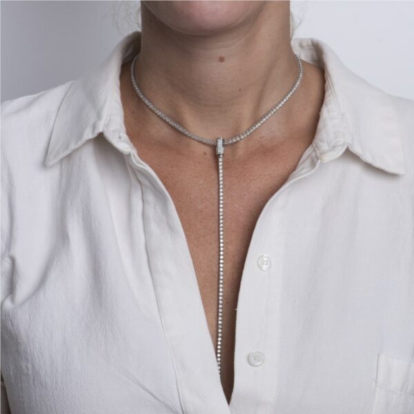 a woman wearing a white shirt and a silver necklace