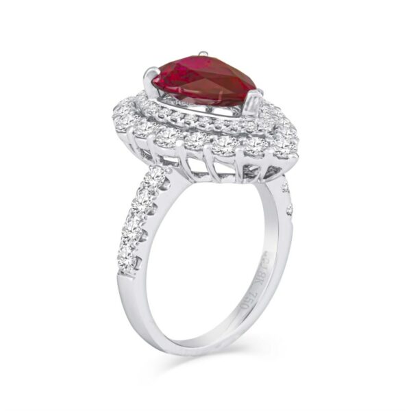 a ring with a pear shaped ruby stone surrounded by diamonds