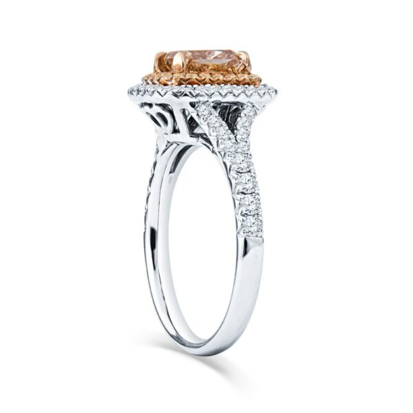 a fancy ring with an orange and white diamond