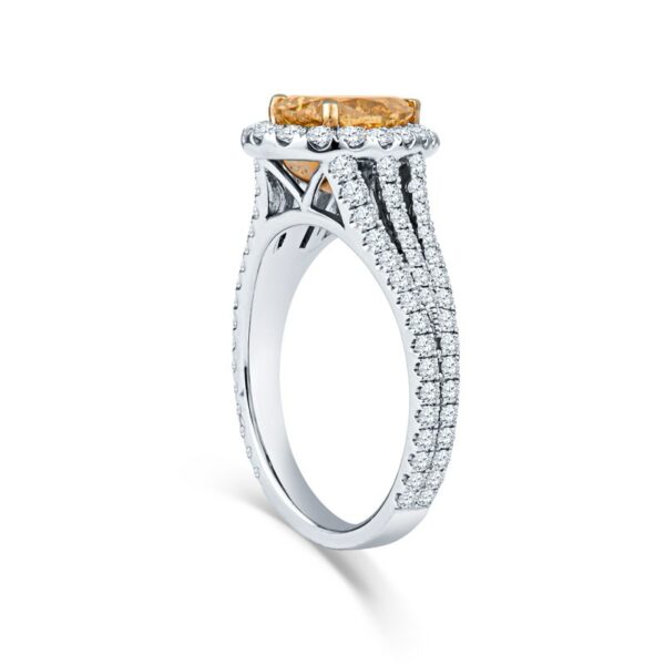 a fancy yellow diamond ring on a white background