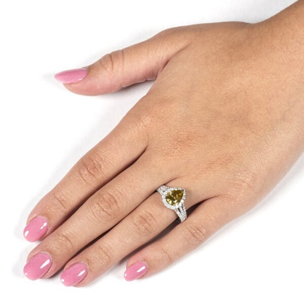 a woman's hand with pink nails and a ring