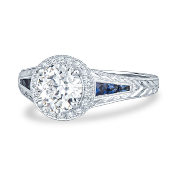 a diamond and blue sapphire ring on a white background