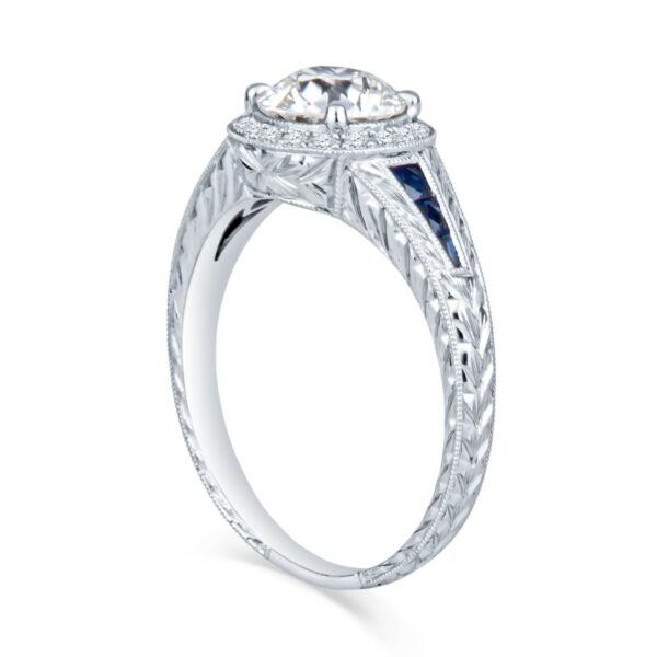 a white gold engagement ring with an oval diamond and blue sapphire stones