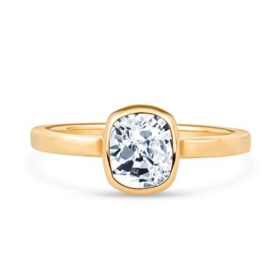 a yellow gold ring with an oval cut diamond