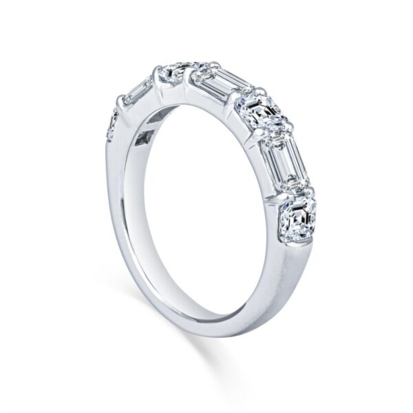 a white gold ring with three baguettes on the side