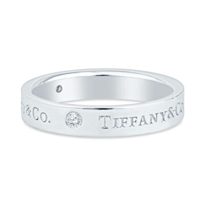 a white gold ring with the word tiffany on it