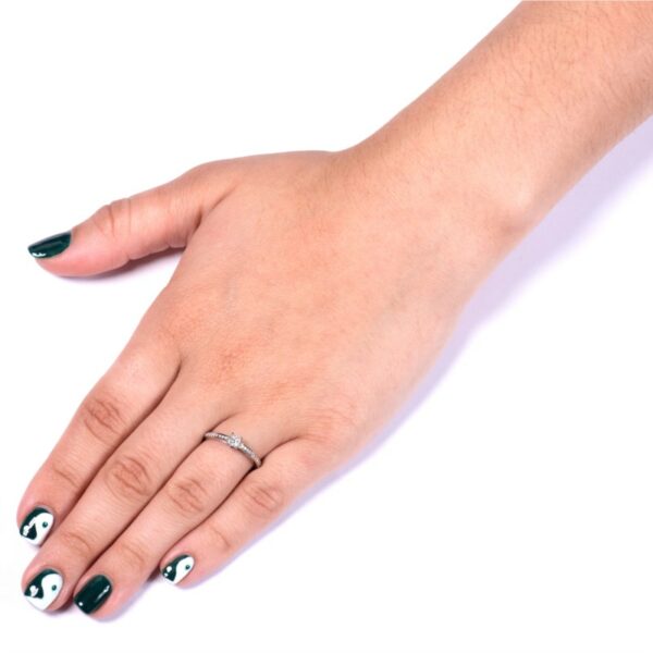 a woman's hand with black and white nail polish