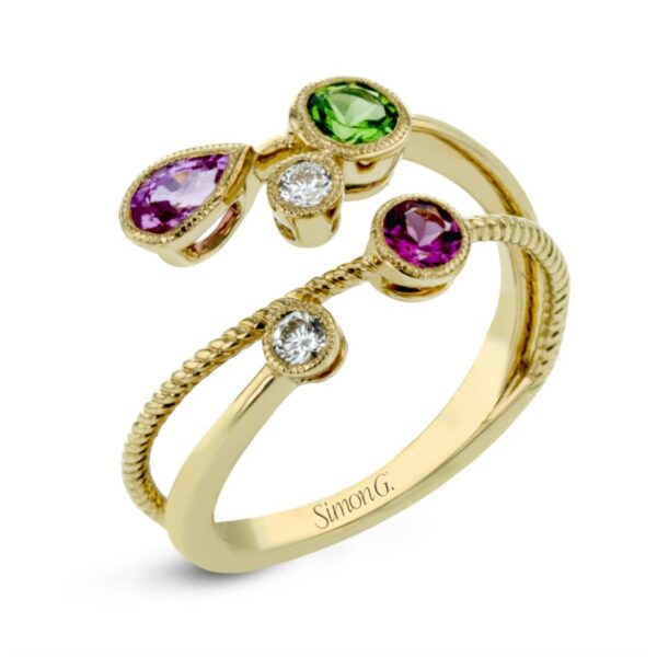 a yellow gold ring with three different colored stones