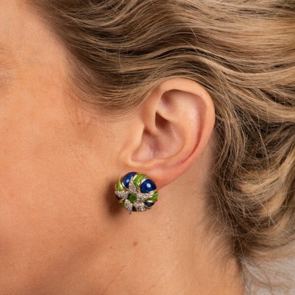 a close up of a woman's ear wearing a pair of earrings