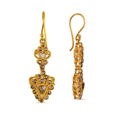 a pair of earrings with gold chains and stones