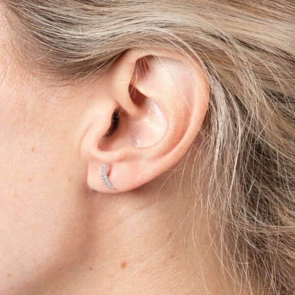 a close up of a person with ear piercings