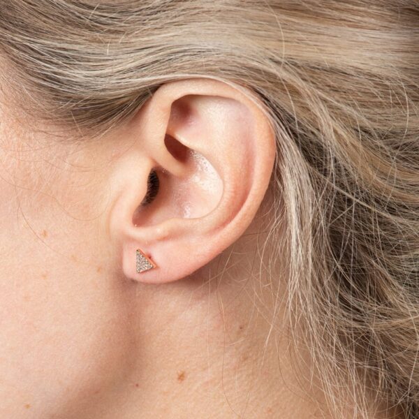 a close up of a person's ear with a diamond in it
