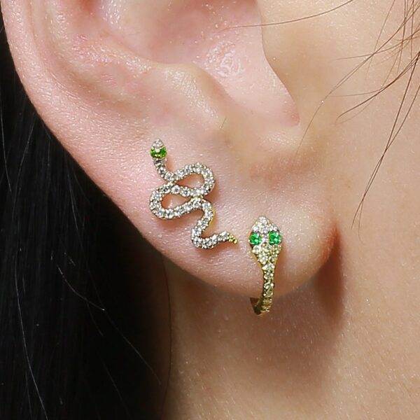a close up of a person wearing two ear piercings
