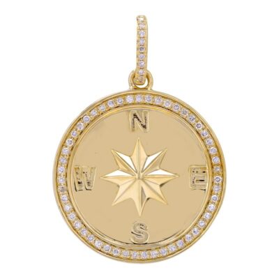a gold compass charm with diamonds on it