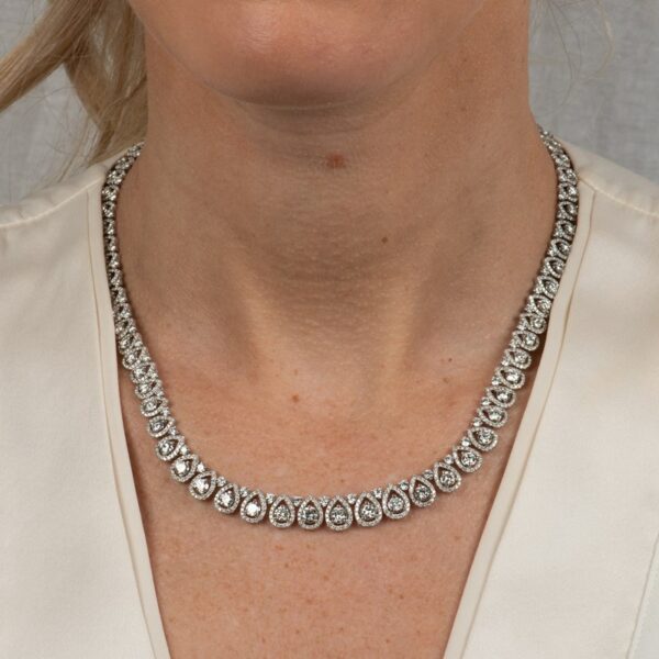 a woman wearing a diamond necklace on her neck
