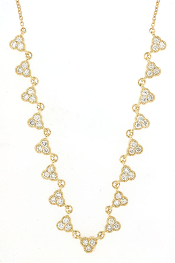 a gold necklace with hearts on it