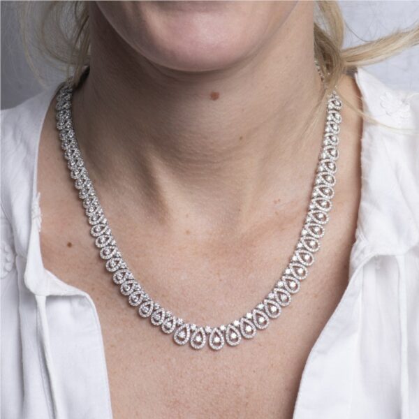a woman wearing a diamond necklace