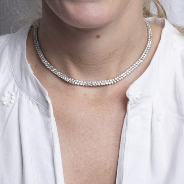 a woman wearing a white shirt and silver necklace