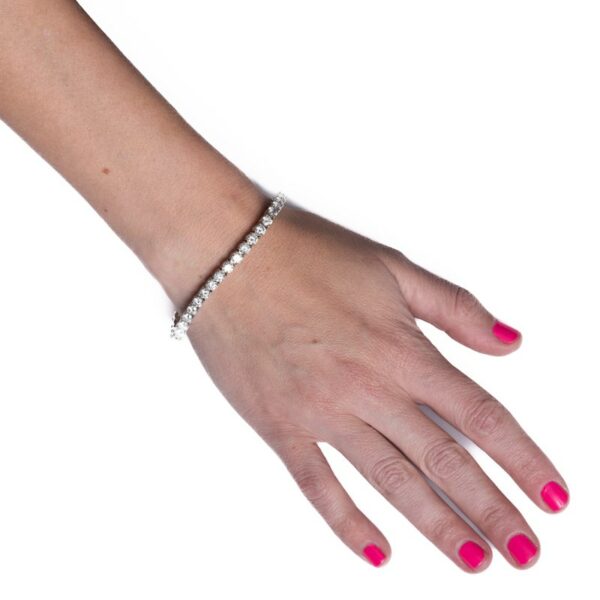 a woman's hand with pink nails and a bracelet