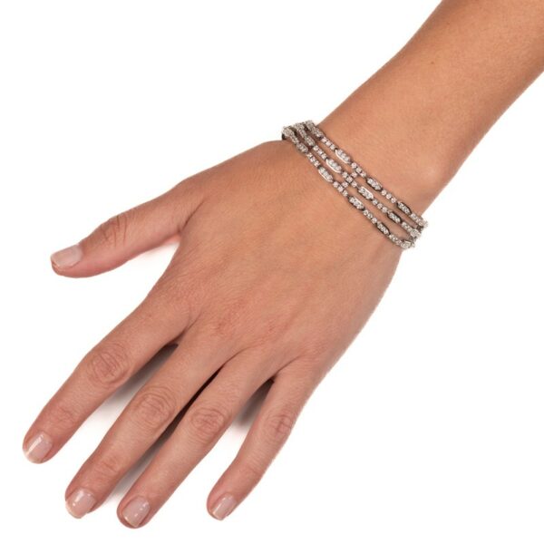 a woman's hand with three bracelets on it
