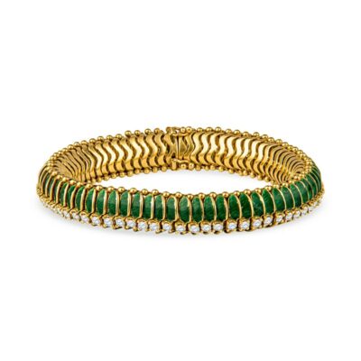 a gold and green bracelet on a white background