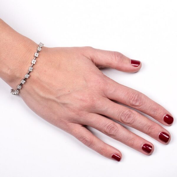 a woman's hand with a red manicure on it