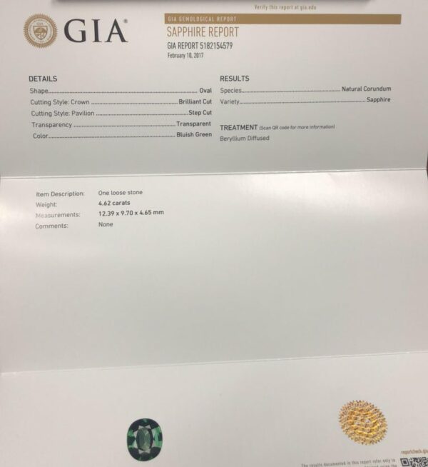 a close up of a white envelope with a gold seal on it