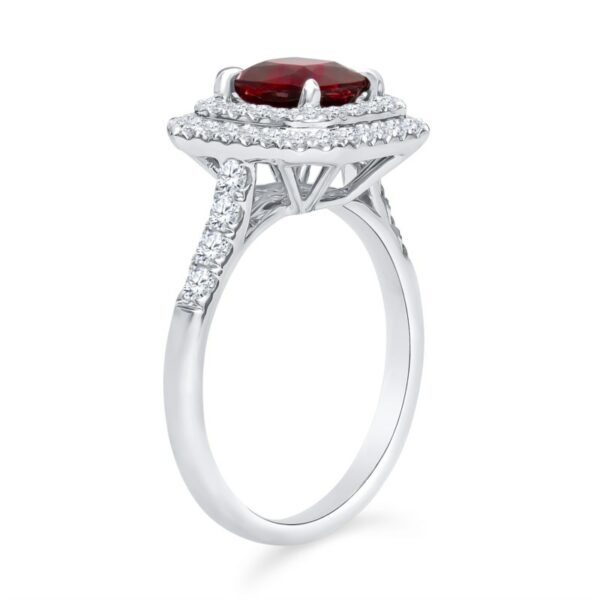 a ring with a red stone surrounded by diamonds
