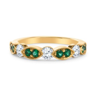 a yellow gold ring with green and white stones