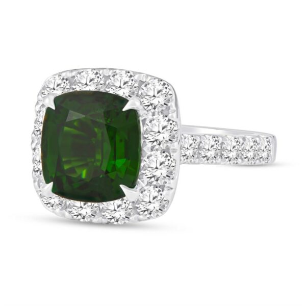 a cushion cut green diamond ring with diamonds around it
