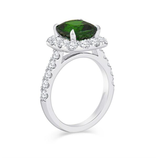 a ring with a green stone surrounded by diamonds