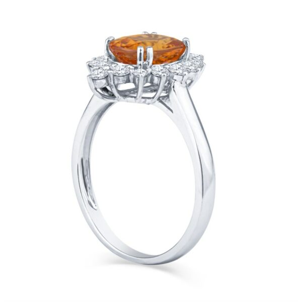 a ring with an orange stone and diamonds