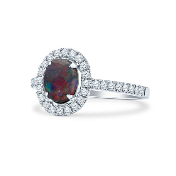 a ring with an oval shaped fire opal surrounded by diamonds