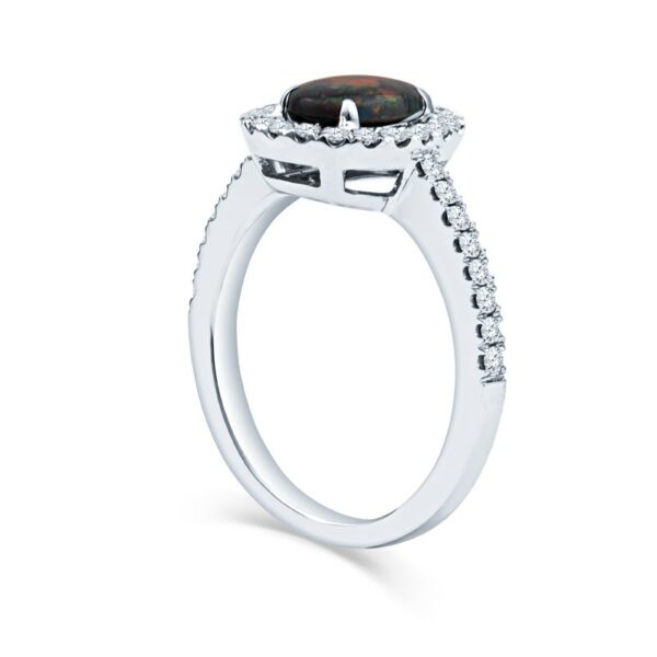 a ring with a black stone and diamonds on it
