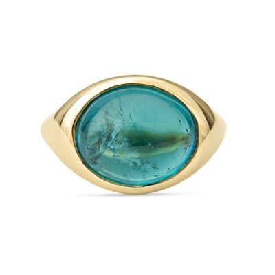 a gold ring with an oval blue stone