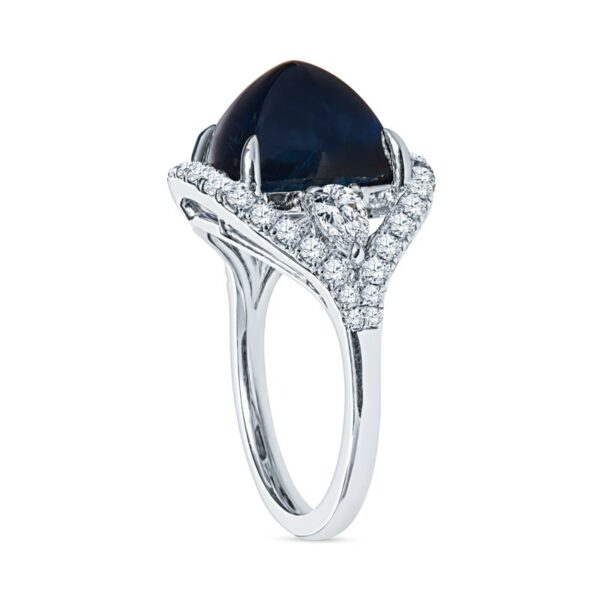 a ring with a pear shaped blue stone surrounded by diamonds