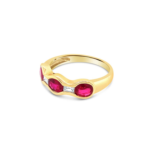 a yellow gold ring with two red stones