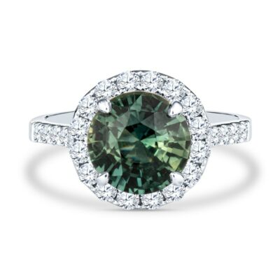 a green and white diamond ring with diamonds around it
