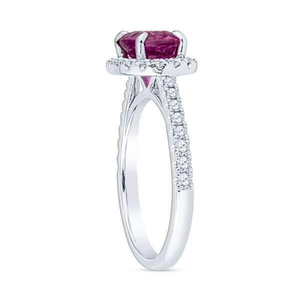 a white gold ring with an oval shaped ruby stone and diamonds
